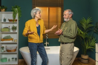 Casual caucasian senior couple discussing and talking standing together in the bathroom