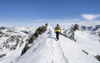 Mountaineer on the summit of the Scalettahorn in winter, Graubünden Haute Route, Albula Alps,