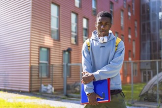 Urban african american student standing proud looking at camera outside the university
