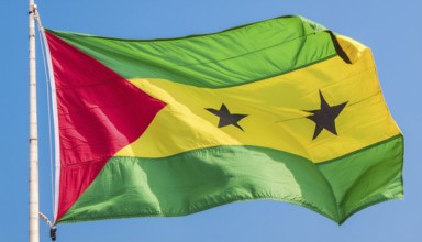 The flag of the Democratic Republic of Sao Tome, Africa, flutters in the wind, isolated against a