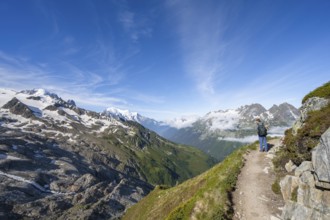 Mountaineer on a hiking trail, view into the valley with summit Mont Blanc, Chamonix, Haute-Savoie,
