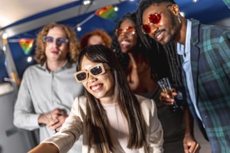 Chinese woman with elegant clothes and sunglasses taking selfie while enjoying night party with