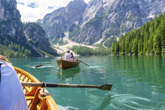Tourists enjoying a boat trip on the stunning lake braies, surrounded by the breathtaking scenery