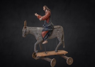 Christ on the palm donkey, on a dark background, wooden figure from around 1400, Museum Bezau,