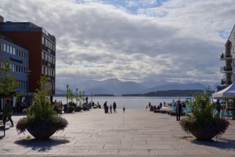 Molde market square, fjord landscape, flanked by buildings, people walking, cloudy sky, calm