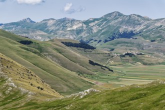 Mountain landscape on the edge of the Pian Grande di Castelluccio di Norcia plateau in the Monti