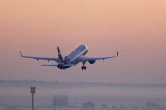 Passenger aircraft after take-off, in front of sunrise, fog, Baden-Württemberg, Germany, Europe