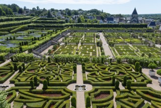 Geometrically designed garden with manicured hedges, labyrinth and architectural elements on a