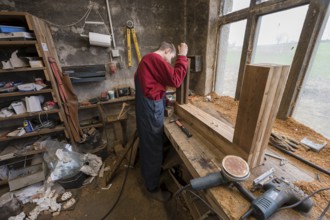 Young man builds a table in his workshop, Mecklenburg-Vorpommern, Germany, Europe