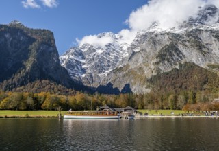 Königssee with Watzmann massif and St. Bartholomä jetty with tourist boat, autumnal mountain