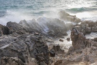 Sea water lashes over the eroded rocks on Salines beach, Ibiza, Balearic Islands, Mediterranean