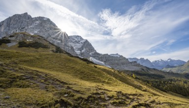 Mountain landscape with yellow meadows in autumn, summit Lamsenspitze with sun star, Karwendel,
