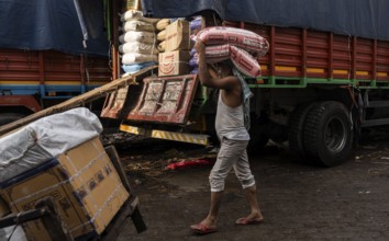 GUWAHATI, INDIA - MAY 1: Labourers carries goods in a wholesale market, in Guwahati, India, on May