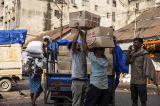 GUWAHATI, INDIA - MAY 1: Labourers carries goods in a wholesale market, in Guwahati, India, on May