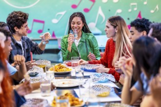 Young multiethnic friends enjoying meals and drinks together in a vintage restaurant, creating a