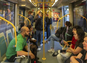 People on metro tram train public transport system, city of Porto, Portugal, Europe