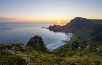 View of coastal landscape at sunset, cliffs and summit of Måtind or Måtinden, Høyvika beach and