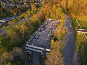 Empty car park surrounded by dense trees and a road in the evening light, rural atmosphere, Nagold,