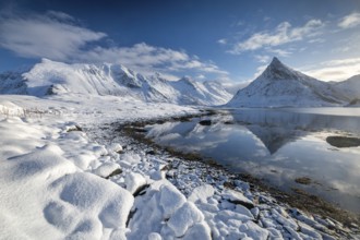 Snowy landscape with mountains and fjord, Volandstinden mountain, Fredvang, Flakstadøya, Lofoten,