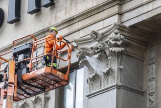 Detroit, Michigan - A worker uses a high-pressure water spray to clean the exterior of the