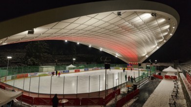 Tourists on ice rink, ice sports stadium, ice skating in the evening, Schierker Feuerstein Arena,