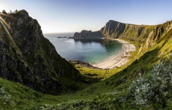 View of coastal landscape, steep coast with peak Måtind, Høyvika beach and sea in the evening