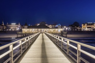 Restaurant on Ahlbeck Pier, Seebrücke Ahlbeck illuminated at dusk in the Baltic Sea on Usedom