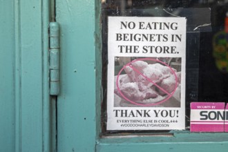 New Orleans, Louisiana - A sign in a store in the French Market asks visitors not to eat beignets