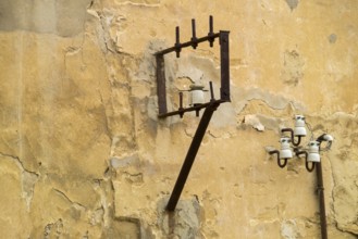 Power lines on a house wall with ceramic insulators, Agrigento, Agrigento, Sicily, Italy, Europe