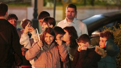 A group of children laughing and covering their ears, fireworks, Easter fire Psinthos, Holy