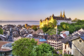 Neuchâtel Castle with view over the town of Neuchâtel at sunrise, behind it Lake Neuchâtel, Canton
