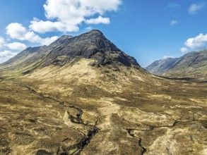 Buachaille Etive Beag and Three Sisters in Glencoe over Moors and Road A82 from a drone, Highlands,