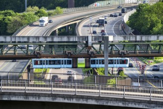 The Wuppertal suspension railway, train of the latest generation 15, crosses the A46 motorway,