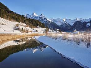 River Sihl flows into Lake Sihl, reservoir, behind the snow-covered mountains Flübrig and