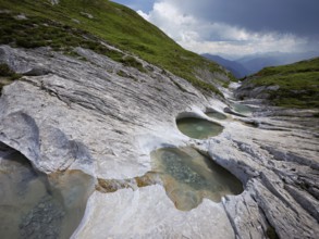 Glacier mill with glacier pots on the Trinser Alp Mora, Trin, Canton Graubünden, Switzerland,
