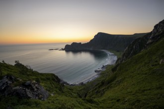 View of coastal landscape at sunset, cliffs and summit of Måtind or Måtinden, Høyvika beach and