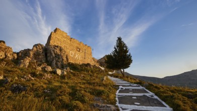 Warm evening light, path to a ruin with tree under blue sky and clouds, Archangelos, castle, place,