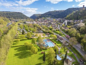Green parkland with pool and town in a mountainous setting, Bad Liebenzell, Calw district, Black