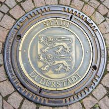 Manhole cover with coat of arms and inscription City of Duderstadt, Lower Saxony, Germany, Europe