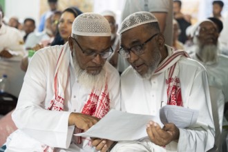 Hajj pilgrims check passport and documents before leaving to the airport, in Guwahati, India on 3
