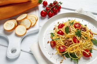 Yellow zucchini salad, with cherry, vegetarian food, sliced into strips, homemade