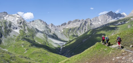 Three mountaineers on a hiking trail on the Daberlenke, view of rocky mountain peaks in the