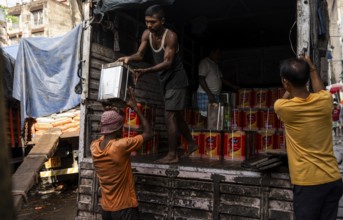 GUWAHATI, INDIA - MAY 1: Labourers carries goods in a wholesale market, in Guwahati, India, on May