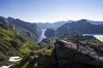 Mountaineer, young woman in front of mountain landscape, fjord Trollfjord and mountains, hike to
