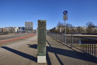 Footpath and cycle path, metal railing, lantern, general architecture, high-rise building, stele