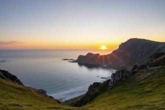 View of coastal landscape at sunset, cliffs and summit of Måtind or Måtinden, Høyvika beach and