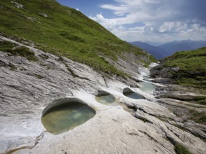 Glacier mill with glacier pots on the Trinser Alp Mora, Trin, Canton Graubünden, Switzerland,