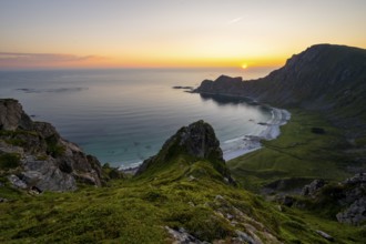 View of coastal landscape at sunset, cliffs and summit of Måtind or Måtinden, Høyvika beach and