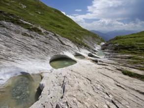 Glacier mill with glacier pots on the Trinser Alp Mora, Trin, Canton Graubünden, Switzerland,