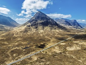 Buachaille Etive Beag and Three Sisters in Glencoe over Moors and Road A82 from a drone, Highlands,